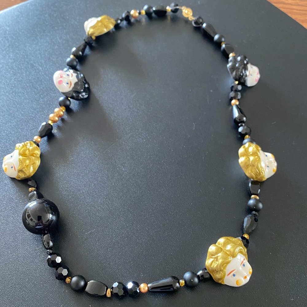 Unlogical Poem big doll head necklace.